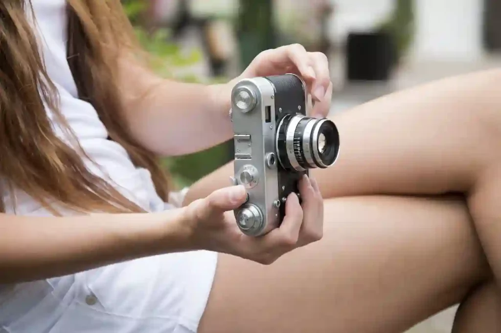 girl holding a camera for picture