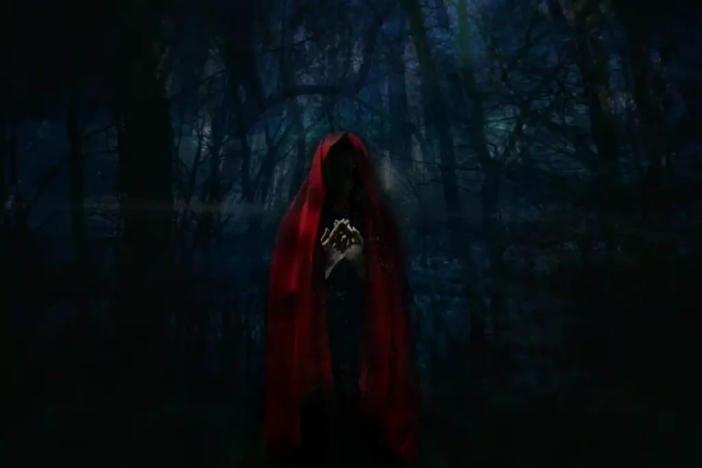 woman-in-cloak-dark-setting