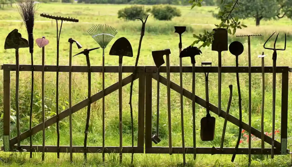 gardening tools on a fence
