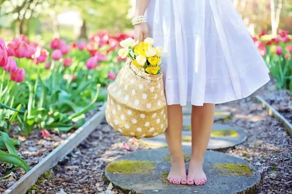 a girl standing in a garden